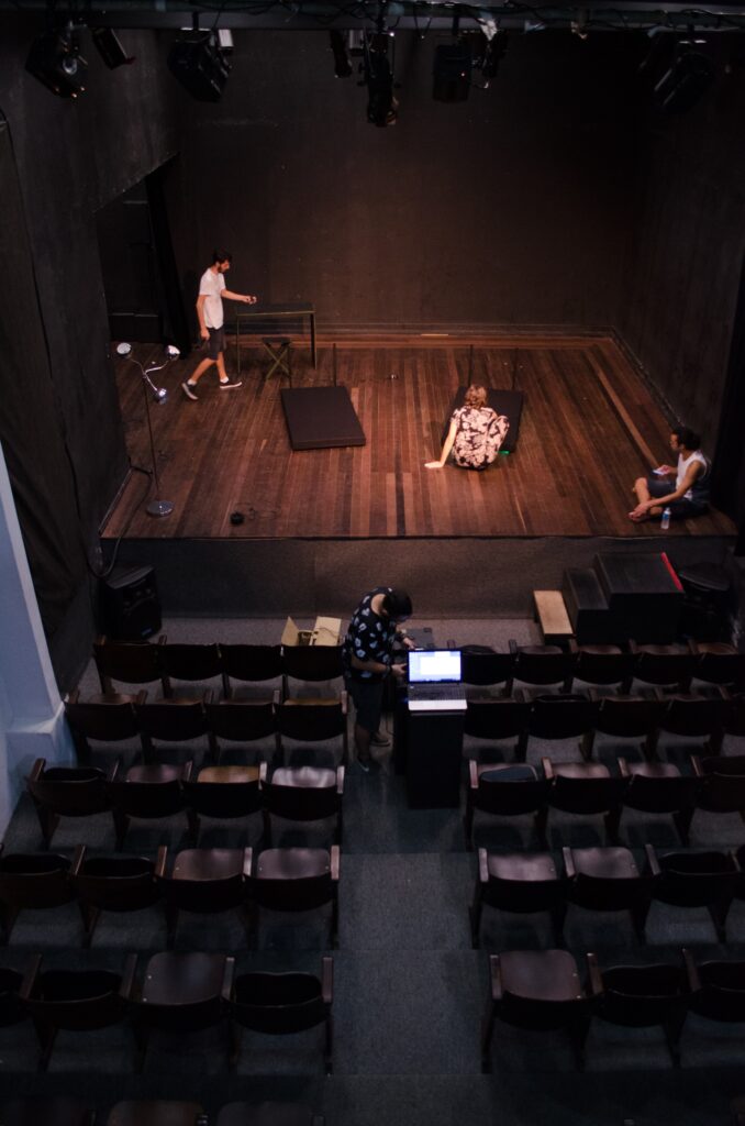 Actors and stage crew work on a staging a play. 